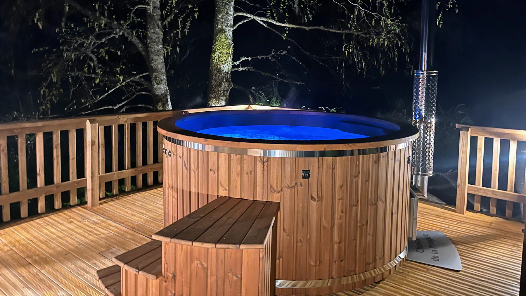 Eau claire d’un bain nordique TimberIN éclairé sur une terrasse